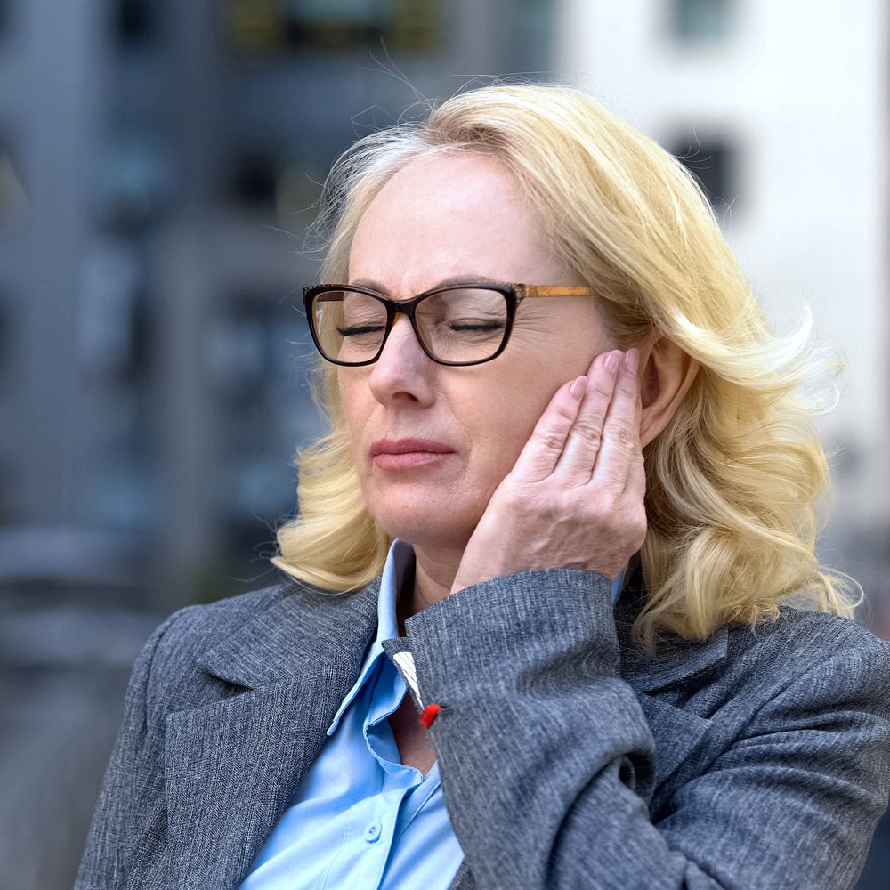 Woman holding a hand to her jaw